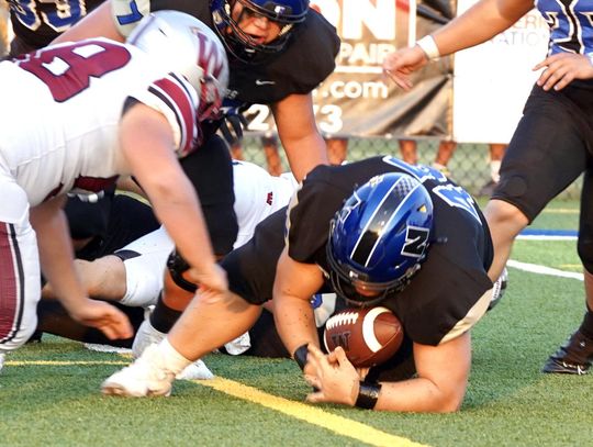 Jaron Webb falls on the loose ball for the Racers during the Weatherford game