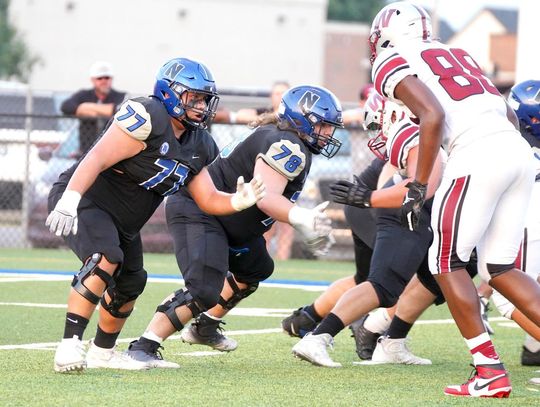 Junior Taj Smith (77) and senior Chas Gentry (78) do their job on the line for Newcastle