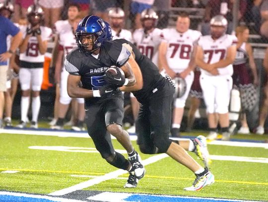 T.J. Bradford (above) takes the handoff on one of his many carries for the Racers during the Friday night game against Weatherford.