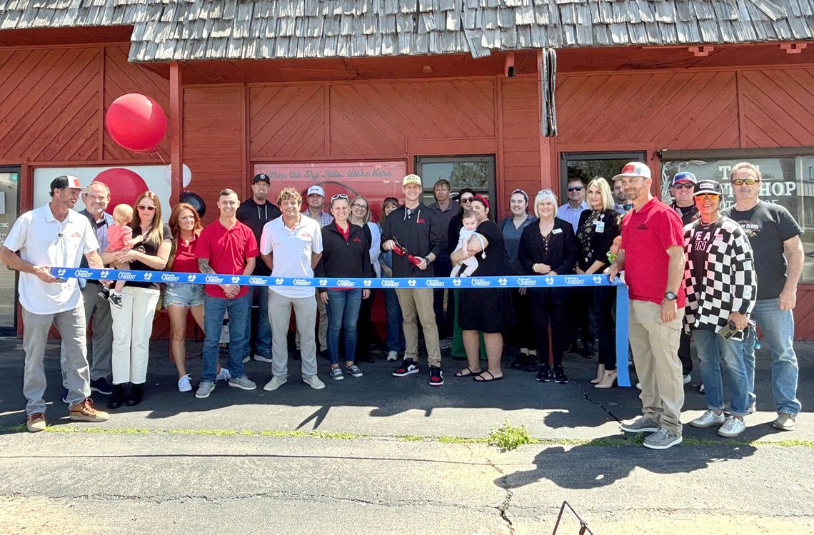 Dynamic Roofing and Construction cuts ribbon here