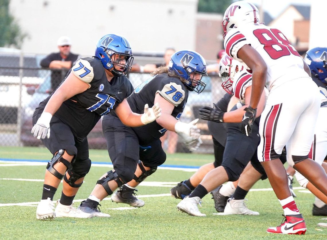 Junior Taj Smith (77) and senior Chas Gentry (78) do their job on the line for Newcastle