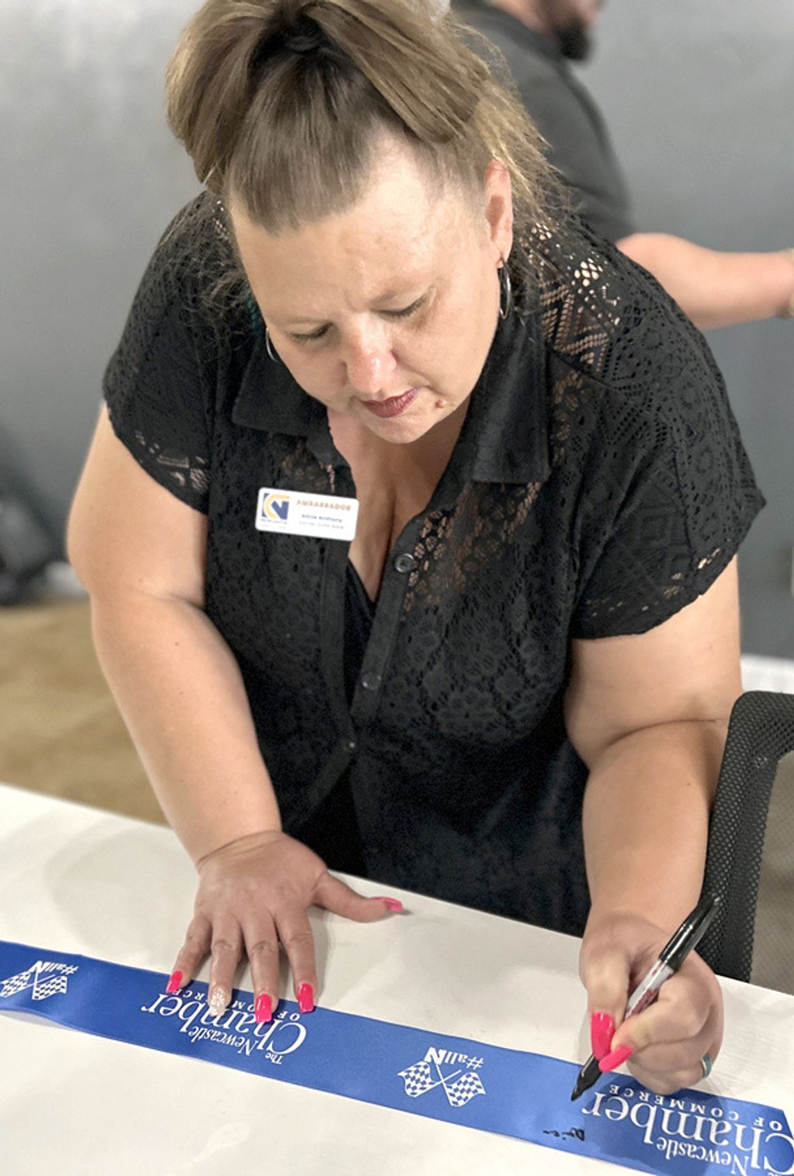 Signing the ribbon