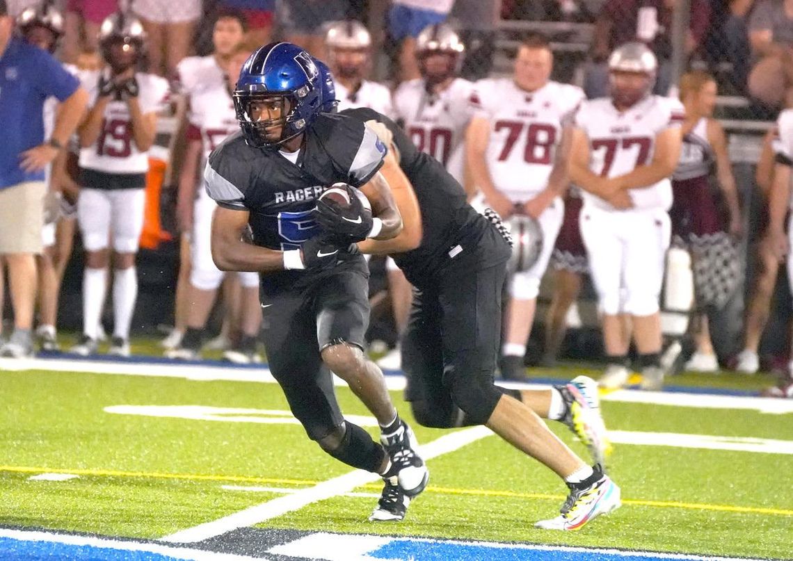 T.J. Bradford (above) takes the handoff on one of his many carries for the Racers during the Friday night game against Weatherford.