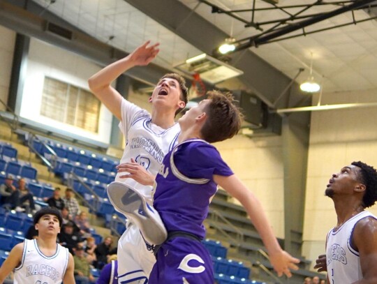 Nathan Ashley puts in a layup in a recent basketball game. Ashley was the Racers’ leading scorer in the opening game of the Sweet Pea Tournament against the Oklahoma City Storm with 17 points. • photo by Jennifer Lewis