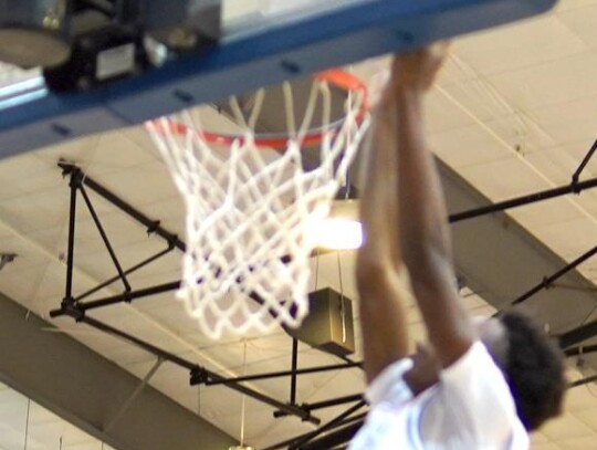 Bobby Burrell went in for the dunk for the Racers during a recent basketball game. • photo by Jennifer Lewis