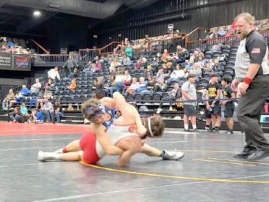 Kage McLean makes the move on his opponent during action at the Midwestern Conference Wrestling Tournament. • photo provided