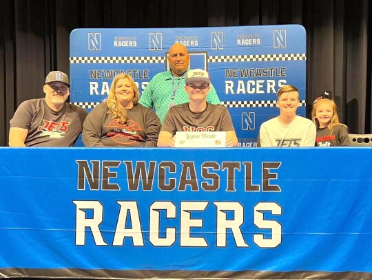 Logan Wade, surrounded by family and Coach Mike Crossley, signs for a baseball scholarship with the Enid-based Northern Oklahoma College Jets.