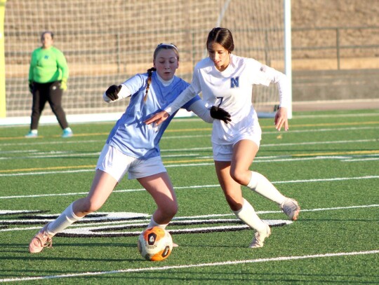 Melia Stucks goes in for the steal during a pre-season soccer match for the Newcastle Racer girls. Their regular season gets underway tomorrow (Friday) at Duncan. •photo by Mindi J Stucks