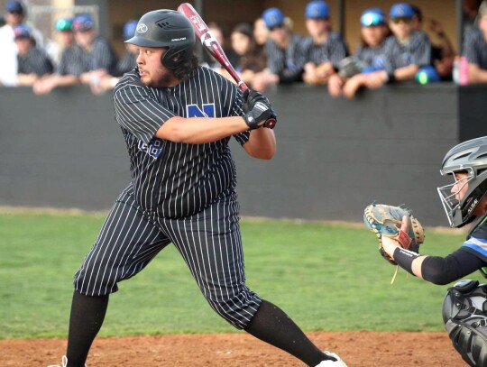 Trey Crossley prepares to connect with a pitch during a Newcastle Racers’ baseball game. • photo by Vickie Crossley