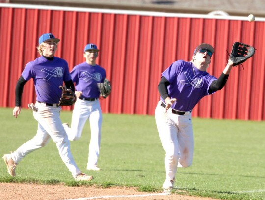 Making the catch for Newcastle is Randy Nix, backed up by Racers Alex Logan and Kaden Longman. The Racers were wearing T-shirts provided by the Purcell Dragons during a recent tournament to raise funds and provide awareness of Trisomy 18, a disorder in wh