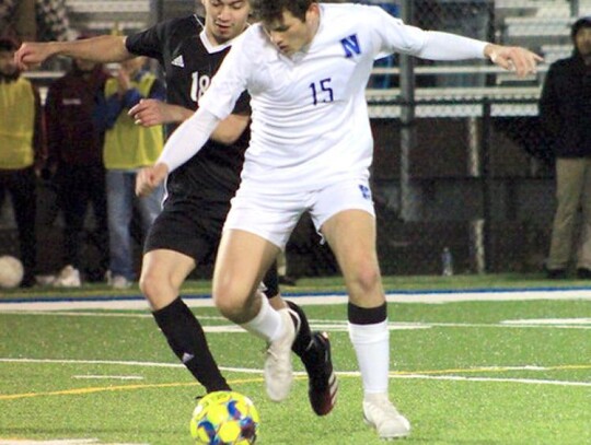 Newcastle junior Justin Hayworth keeps the ball from his opponent during recent Racer soccer. • photo by Mindi Stucks