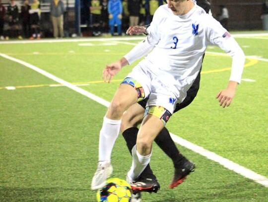 Grahm Griffin, a Racer junior, works the ball for Newcastle. • photo by Mindi Stucks