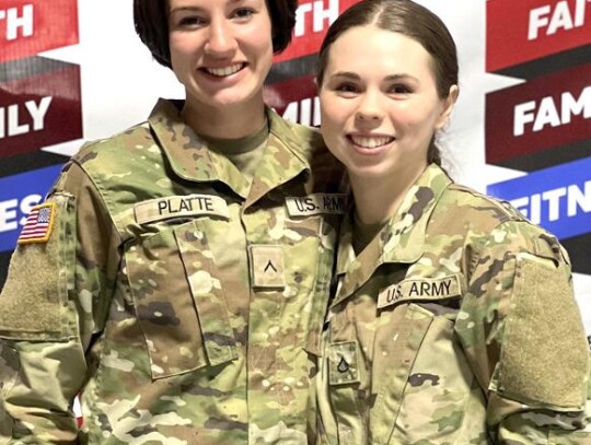 High school seniors Karli Platte (PV2) and Kayle Farrington, (PFC) members of the Oklahoma National Guard, came to the grand opening directly from their drill station. • photo provided