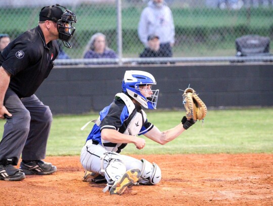 Racer catcher James Folsom makes the catch during a recent game while surveying the playing field for any additional action. • photo by Vickie Crossley