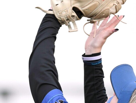 First baseman Addison McCann makes the catch on a fly ball during the Regional slow-pitch softball tournament. • photo courtesy of Brian Blansett