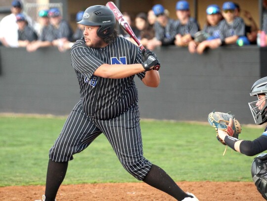 Trey Crossley keeps his eye on the incoming pitch during the Bridge Creek Regional baseball game. • photo by Vickie Crossley