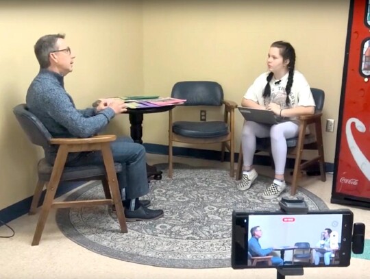 Newcastle Middle School 8th grader Skyeleigh Wood (right) interviews Newcastle Pacer editor Mark Codner about newspaper journalism. The taped interview was then shown to all the English classes at NMS as they studied a short unit on newspapers. • photo 