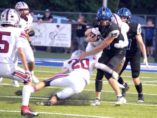 Senior quarterback Jackson Bergt moves a defender out of his way during the Friday night football game against the Weatherford Eagles. • photo by Jennifer Lewis