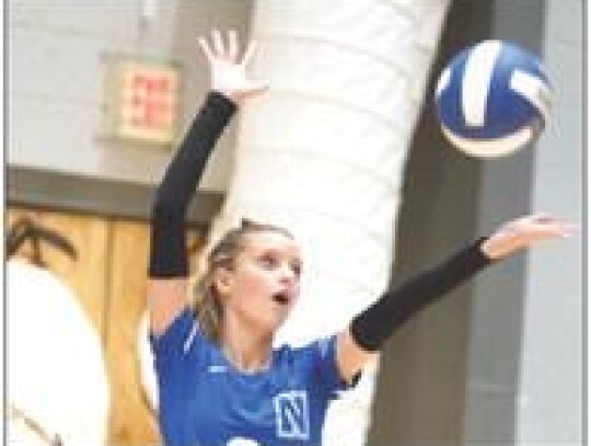 • photo by Jennifer Lewis Abbie Thurman serves the ball for the Racer Volleyball team in recent action.