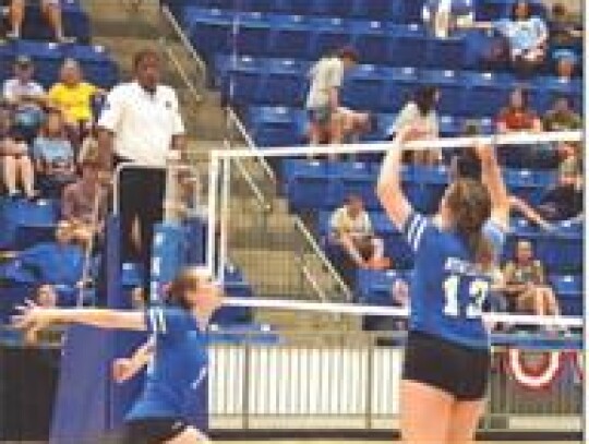 • photo by Jennifer Lewis Amber Ellis (#13) sets the ball for Presley Shelton during a recent match.