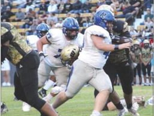 Big guys Taj Smith and Jaron Webb look for the tackle in the Newcastle-Woodward game Friday night. • by Lisa Smith-Longman