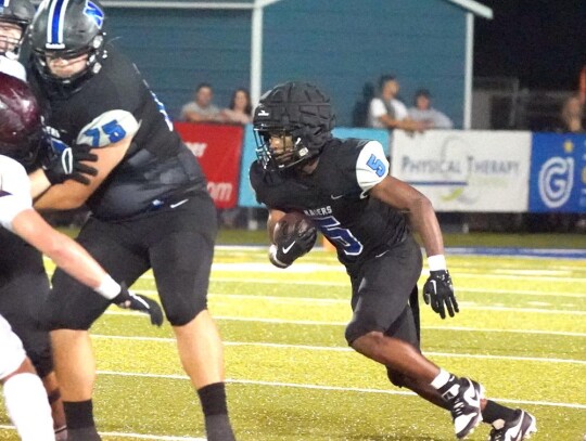 Game Most Valuable Player TJ Bradford takes the ball for the Racers against Blanchard. • photo by Jennifer Lewis