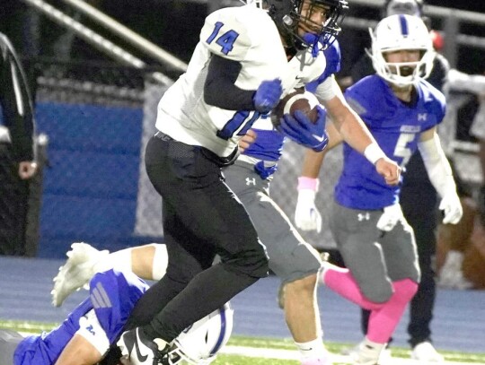 • photo by Jennifer Lewis Jalen Lane runs the ball for the Racers during the Friday night Bridge Creek football game.