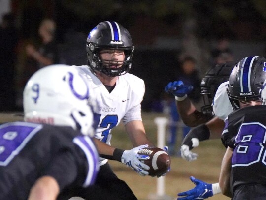 Quarterback Jackson Bergt watches the play develop as he prepares to hand off the ball during a play in Friday night’s game against Bethany. • photo by Jennifer Lewis