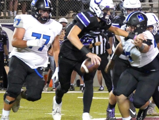 Taj Smith, named the game’s most valuable player for Newcastle, goes after the Bethany quarterback along with Clayton Riggs. • photo by Jennifer Lewis