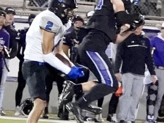 Aden Shumard wrangles in a catch amongst the Bethany defense. • photo by Jennifer Lewis