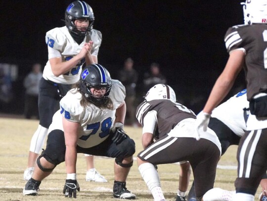 Senior lineman Charles Gentry prepares to protect quarterback Jackson Bergt during the Elk City playoff game Friday night. • photo by Jennifer Lewis