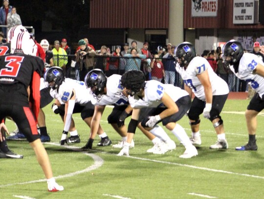 Quarterback Jackson Schanuel readies the Racers for the snap during action at the Newcastle-Poteau State Playoff game Friday night. He’s protected by Maddox Birdsong, Chad Craft, Ayden Elcyzyn, Barry Hunter, and Taj Smith. • photo by Lisa Smith-Longma