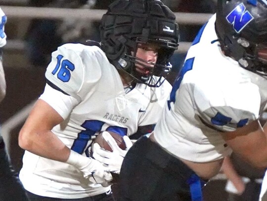 Trey Burchett runs behind a lineman during one of his carries for the Racers. • photo by Jennifer Lewis