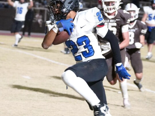 Jordan Lane makes his way upfield during a carry for the Racers in the State Playoffs. • photo by Jennifer Lewis