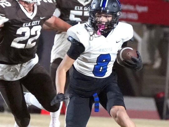 Kaden Longman avoids a couple of Elk City tacklers during a run at the State Playoffs. • photo by Jennifer Lewis