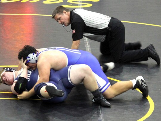 Junior Nicholas Lozano puts his opponent to the mat during a recent wrestling match for the Newcastle Racers. • photo by Valerie Dobbs