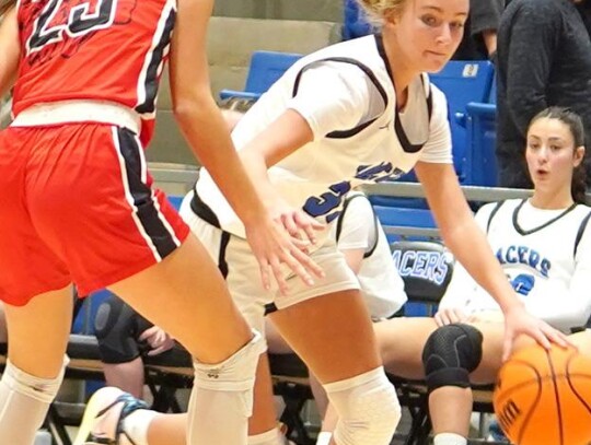 Freshman guard Ava Snider dribbles around her Comanche opponent in December basketball action for Newcastle. • photo by Jennifer Lewis