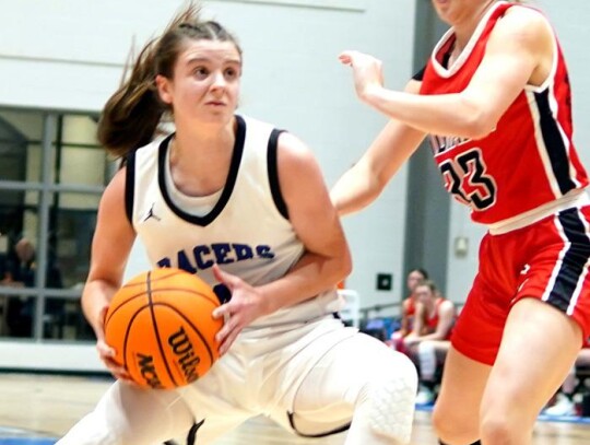 Reagan Greenroyd puts the move on a Comanche player during a basketball game for the Racer girls. • photo by Jennifer Lewis