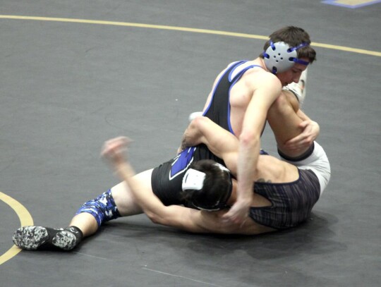 Sophomore K’den Davis (120) puts the move on his opponent during a recent Newcastle wrestling match. • photo by Valerie Dobbs