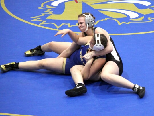 Newcastle sophomore Kaitlynn Steinhour (170) works the mat to move a Noble wrestler into a more advantageous position. • photo by Valerie Dobbs