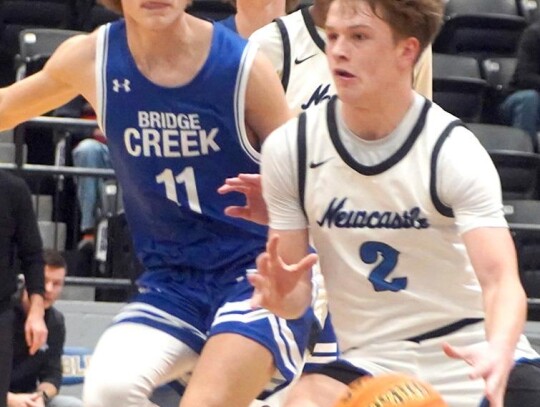 Racer Rex Heskew drives towards the basket in a recent Newcastle varsity basketball game. • photo by Jennifer Lewis