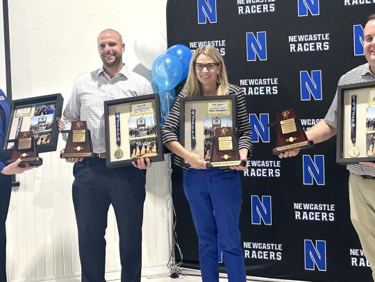 Shadow boxes made by Crossley were also in the presentation to Newcastle administrators to show them their appreciation for the Newcastle Fast-Pitch program. Pictured are: Dr. Cathy Walker, superintendent of schools; Adam Hull, NHS principal; Kristi Fergu