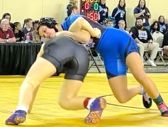 Racer 120 lb sophomore Addison Schuringa scores a takedown on her opponent Megan Aaron of Midwest City. • photo by Ariadne Hale