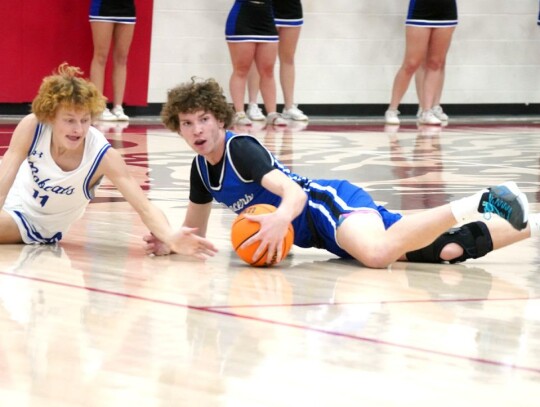 Zachary Cragg scrambles for the ball against a Bridge Creek player during the Regional Tournament. • photo by Jennifer Lewis