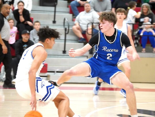 Rex Heskew guards a Bridge Creek opponent during the Regional Tournament last Thursday. • photo by Jennifer Lewis