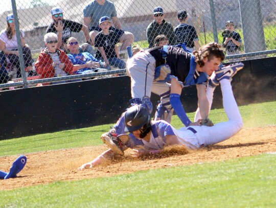 Kaden Longman goes in head first for the Newcastle score during opening season play. • photo by Lisa Longman-Smith