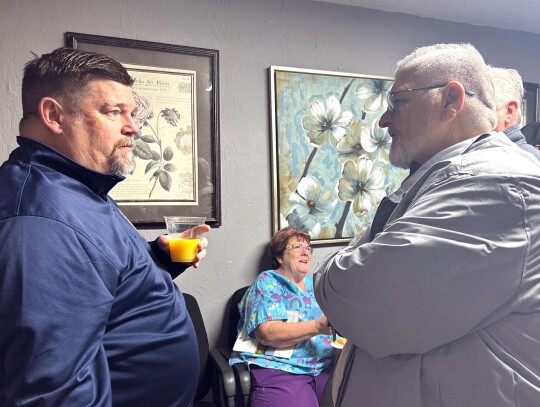 Newcastle minister Billy Collier talks with State House District 20 candidate Lonnie Burns during the Morning Mingle.