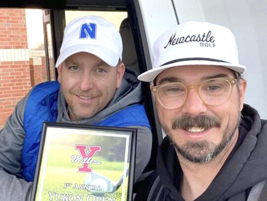 Boys Golf Coaches Jeff Brickman and Keith Meek show a firstplace plaque won by the Racer boys team.