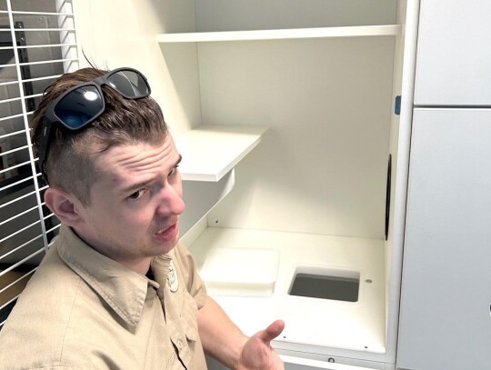 Animal Control officer Tyler Brasseaux explains the Cat Condos to those on a tour at the new Animal Shelter.