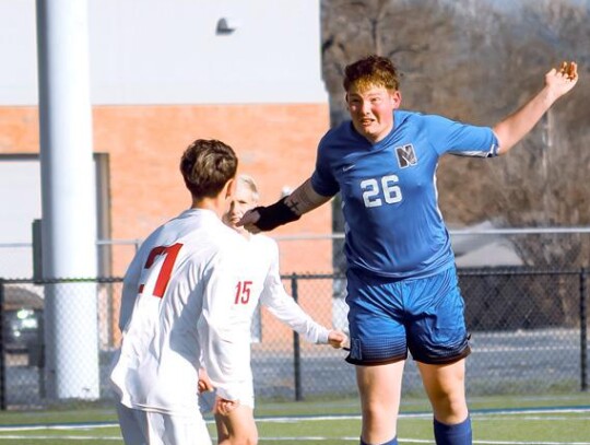 Carl Taylor uses his head to keep the ball in play for the Racers. • photo by Mindi Stucks